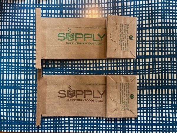 Two wooden packages with 'SUPPLY' branding on a blue grid background